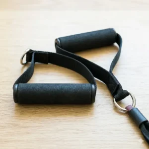 Ergonomic foam handles used as comfortable attachments for resistance bands for upper body workouts