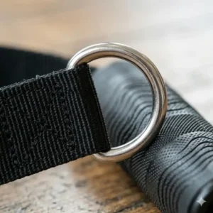 Illustration of a stainless steel D-ring on an exercise strap handle for easy attachment to cable machines or carabiners.