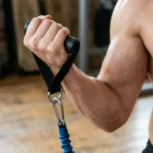 A person using exercise strap handles to perform bicep curls with a blue resistance band.