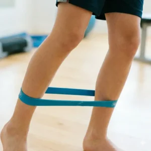 Using loop-style youth resistance bands for lower body and leg strengthening exercises.