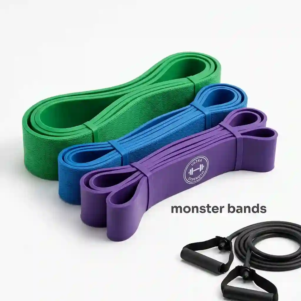 A complete set of multi-colored heavy duty monster bands laid out on a white background with gym handles and attachments.